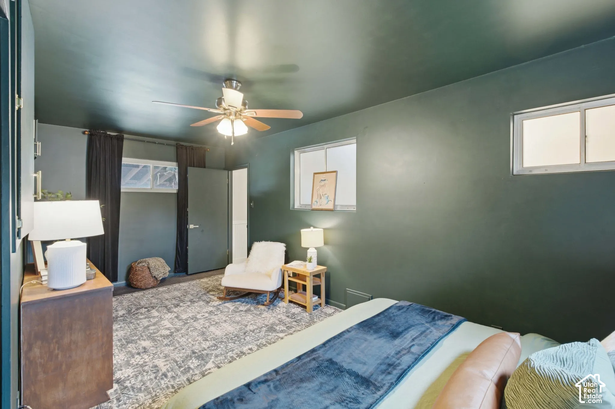 Spacious room featuring dark walls, and multiple windows to allow for natural light.