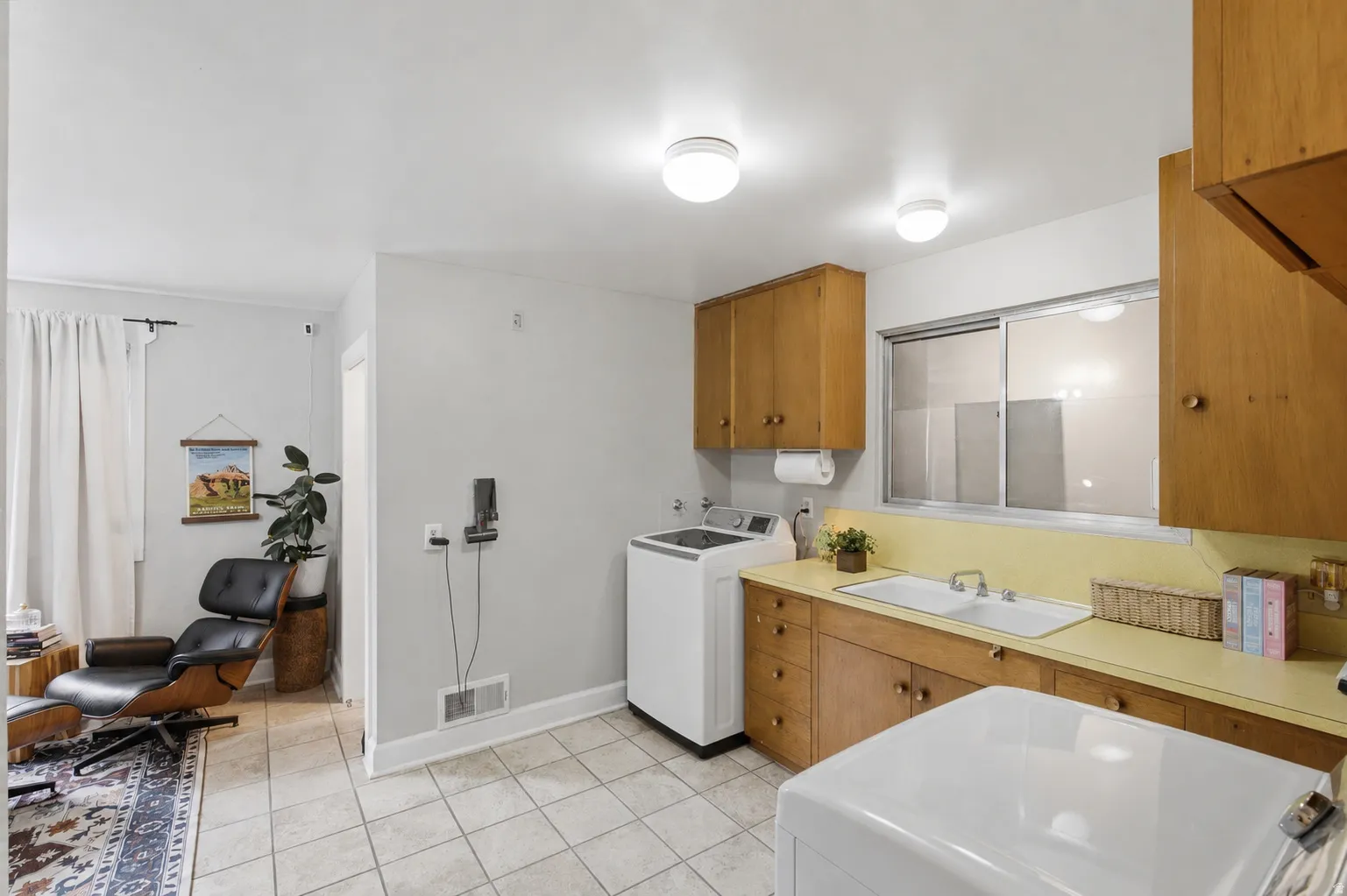 Laundry room includes countertop and double basin sink.