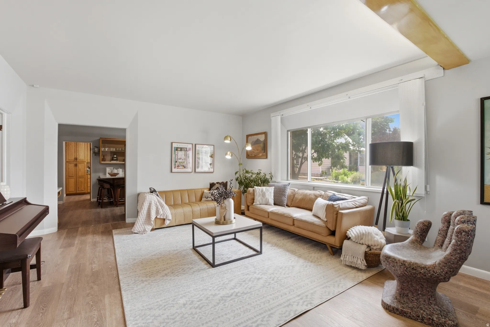 Spacious living area featuring a large window providing ample natural light.