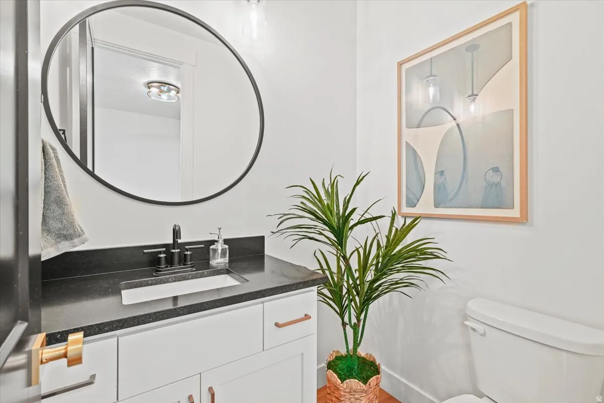 Bathroom vanity featuring a rectangular undermount sink, dark countertop, and matte black faucet