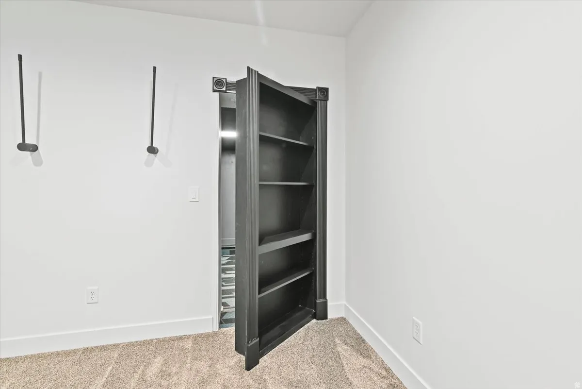 Integrated bookshelf door providing hidden room access