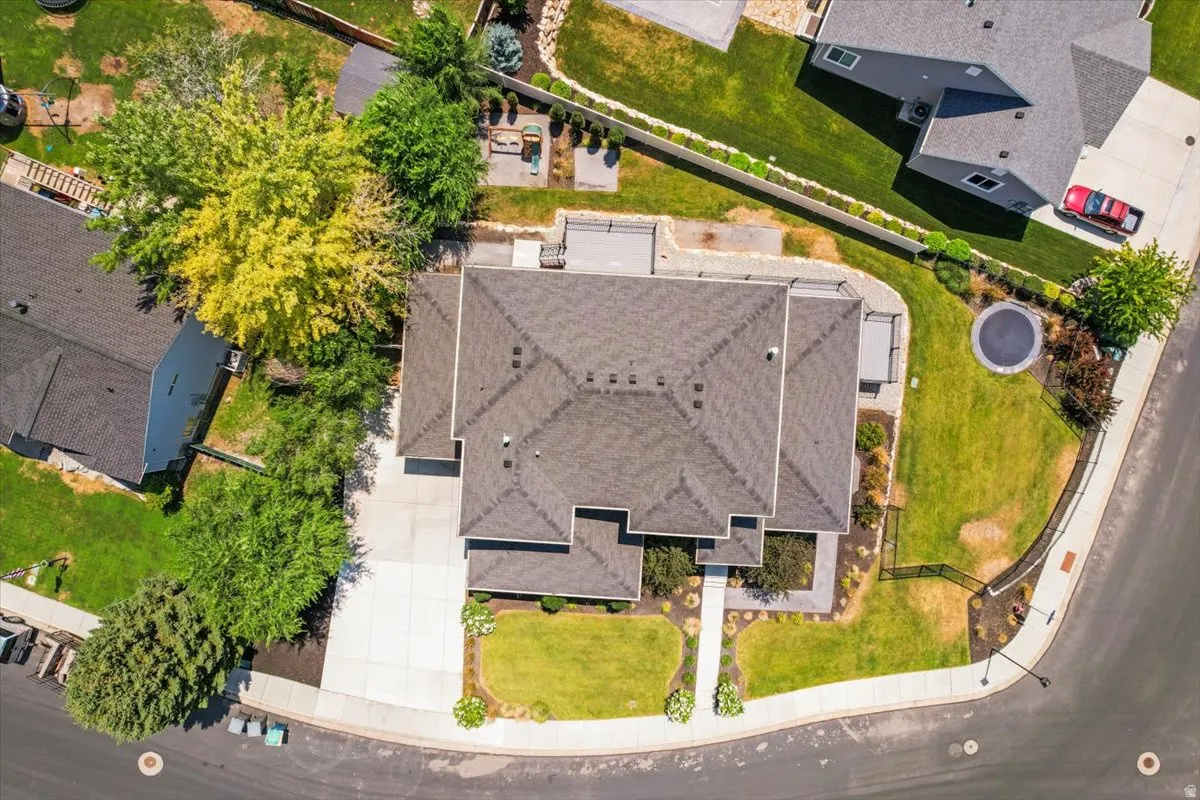 Aerial view showcasing this residence's impressive footprint with a multi-level design, expansive roofline with architectural detailing, and professionally landscaped grounds