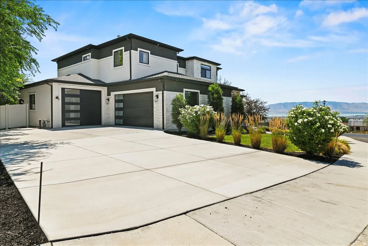Modern two-story residence featuring a striking black and cream exterior with contemporary architectural lines