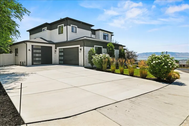 Modern two-story residence featuring a striking black and cream exterior with contemporary architectural lines