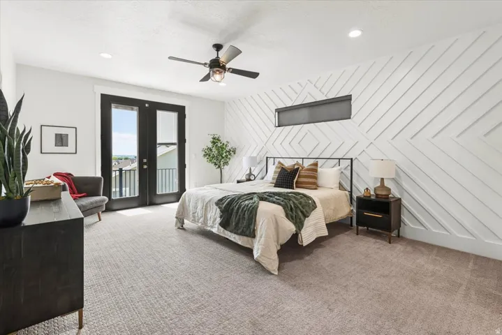 Room featuring a patterned accent wall, French doors with exterior balcony, recessed lighting, and a ceiling fan