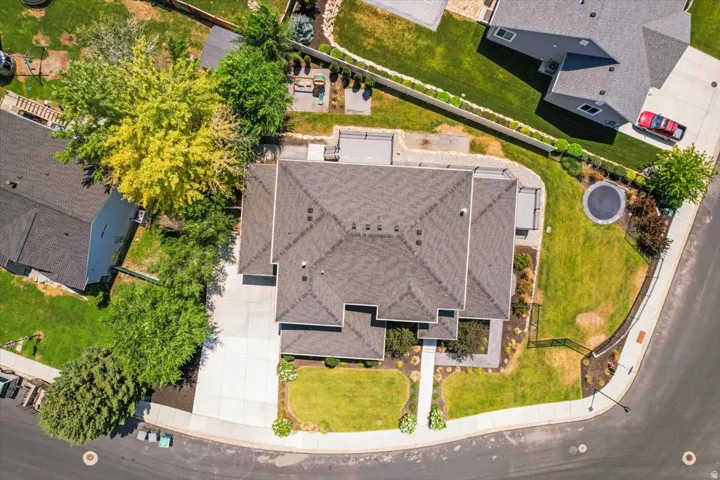 Aerial view showcasing this residence's impressive footprint with a multi-level design, expansive roofline with architectural detailing, and professionally landscaped grounds