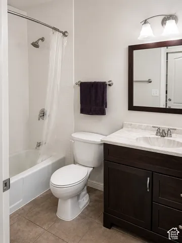 Dark wood-finish vanity with a light-toned countertop, integrated sink, and brushed nickel hardware