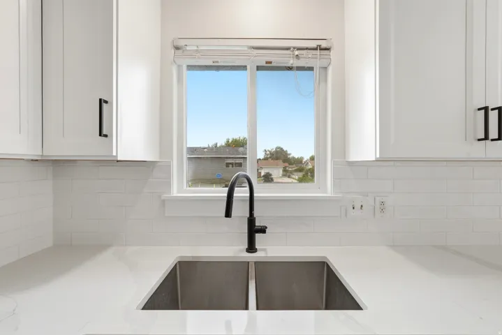 Stainless steel double basin sink with a matte black faucet