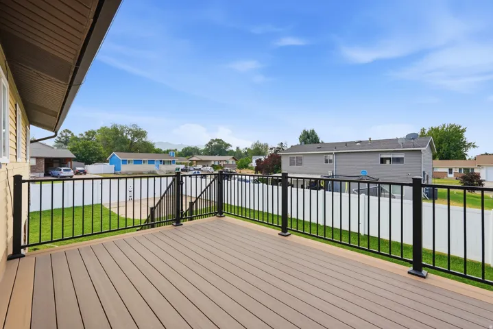 Expansive outdoor deck featuring composite decking and black metal railings