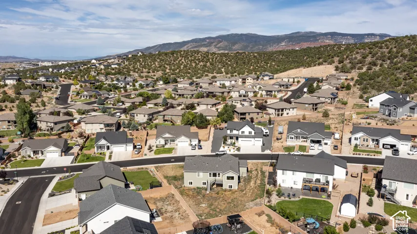 Residential community featuring a variety of architectural styles, paved roadways, and integrated landscaping