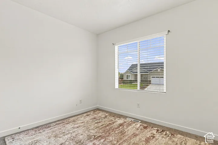 Windowed room featuring light-colored walls and baseboards