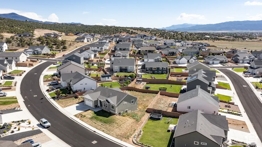 Aerial perspective of a contemporary residential development featuring multiple single-family homes with varied exterior finishes and attached garages