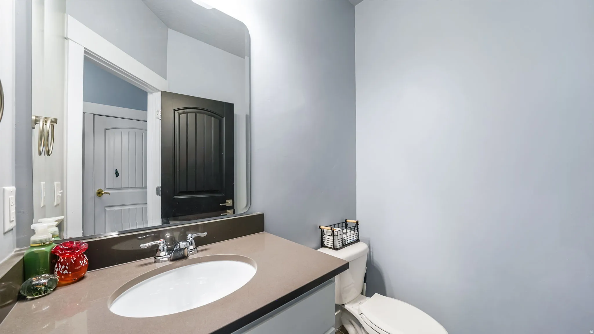 Vanity with a polished countertop, undermount sink, and chrome faucet