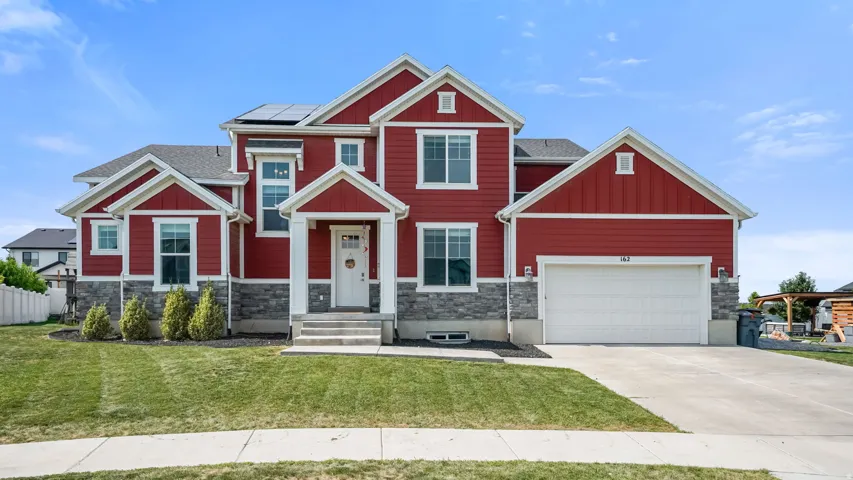 Red siding exterior with white trim accents and stone veneer detailing