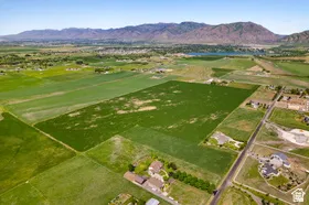Expansive land parcel featuring open fields and distant mountain ranges