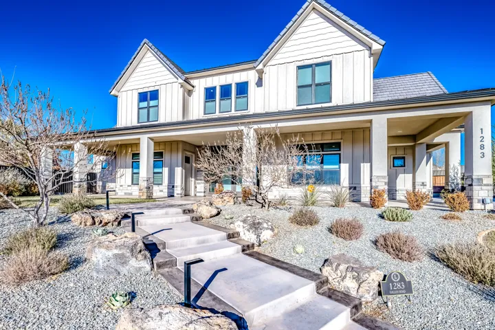 Contemporary exterior featuring board and batten siding with stone accents
