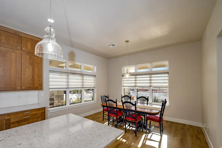 Kitchen and dining area featuring wood-finish flooring