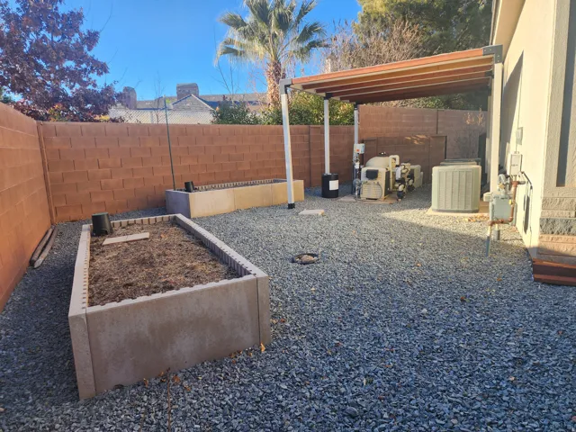 Gravel landscaping with two raised garden beds