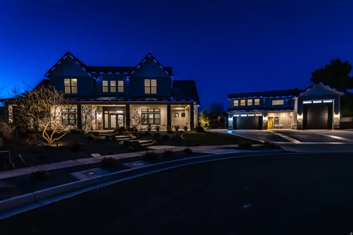 Contemporary two-story residence with a covered front porch and stone accents