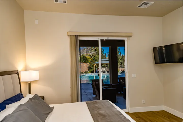 Sliding glass doors opening to an outdoor pool area with a covered gazebo