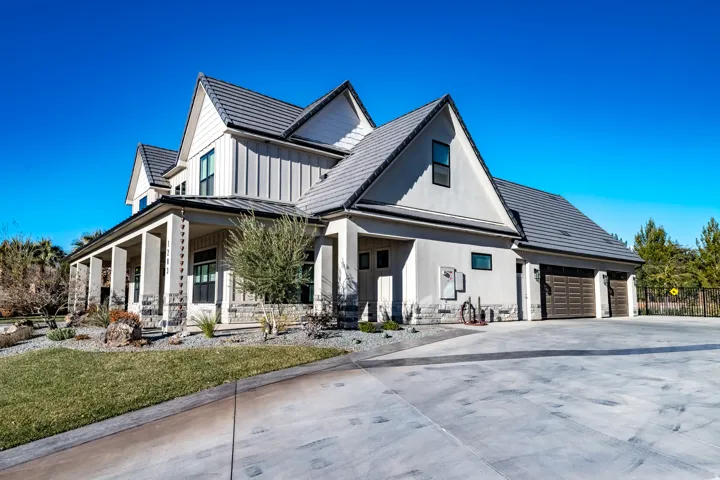 Modern farmhouse exterior featuring board-and-batten siding, stucco finishes, and stone accents
