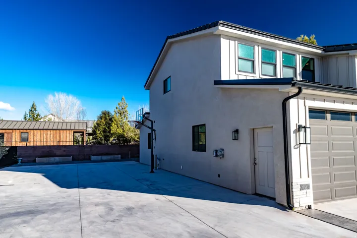 Driveway area with basketball hoop and garden area