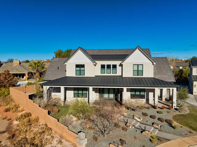 Contemporary two-story residence featuring a gray board-and-batten and stucco exterior