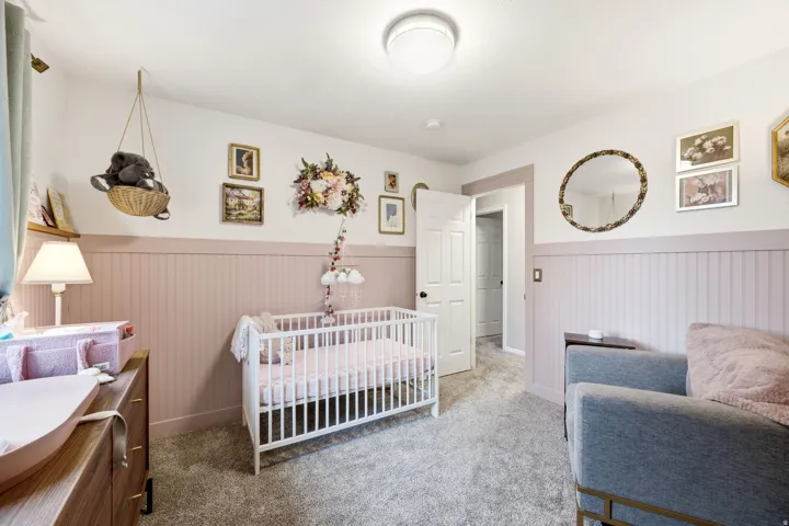 Room featuring wainscoting, wall-to-wall carpeting, and a flush mount ceiling light
