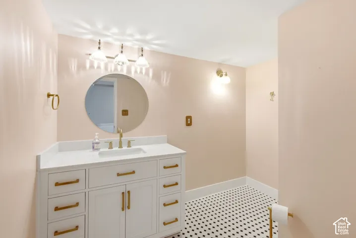 Lovely and spacious bathroom with stylish vanity and lighting fixtures.
