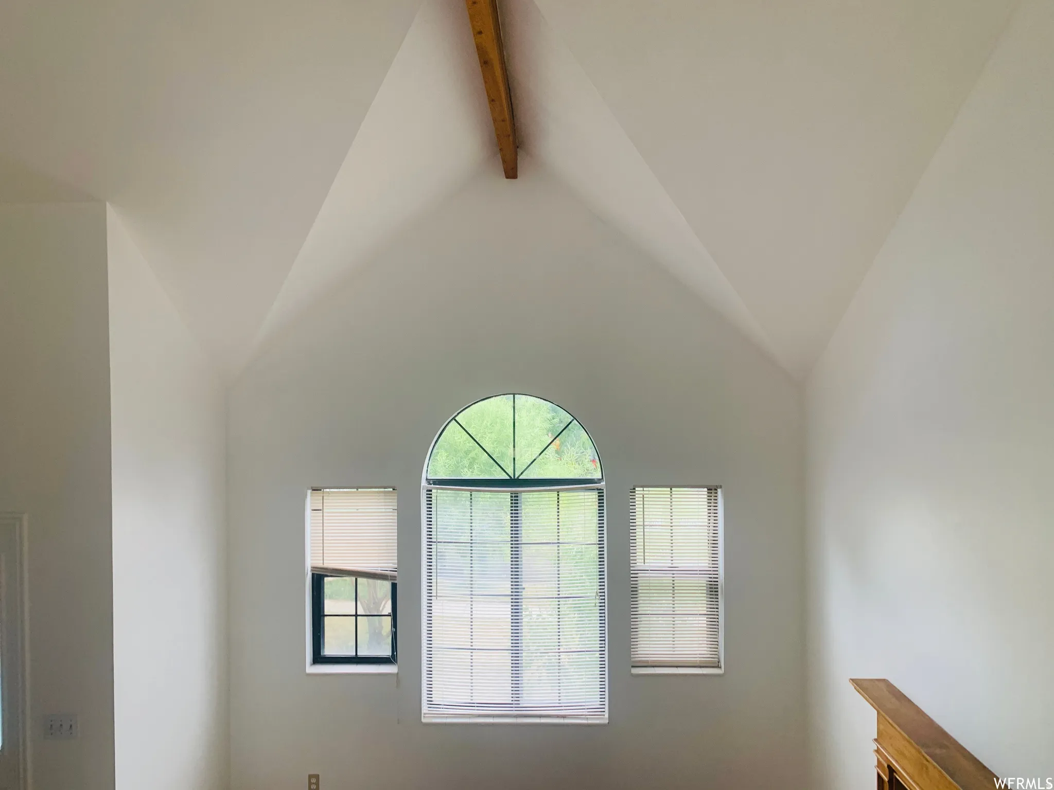 Vaulted ceiling with an exposed wood beam