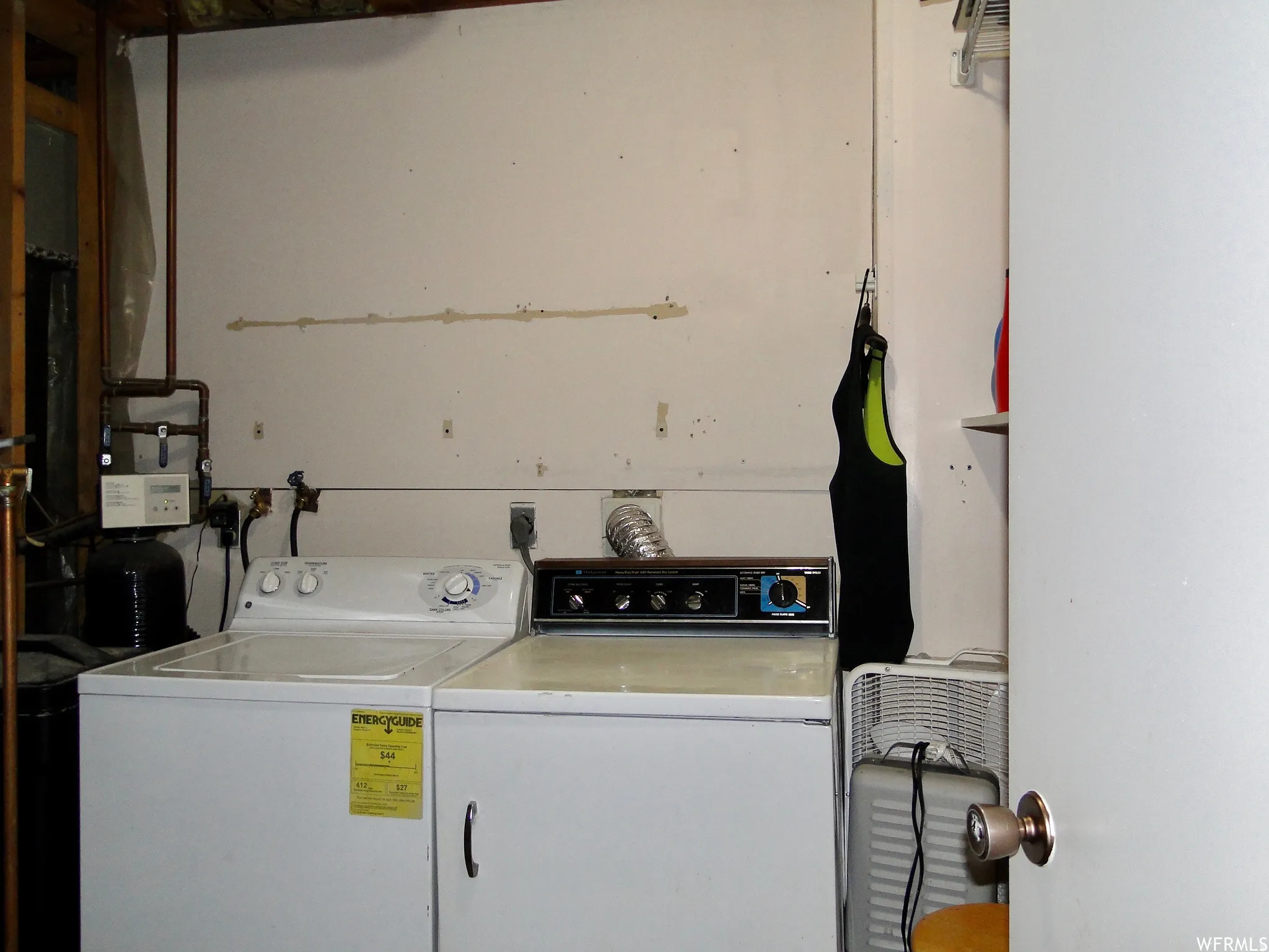 Dedicated laundry area featuring a top-load washing machine and a front-load dryer