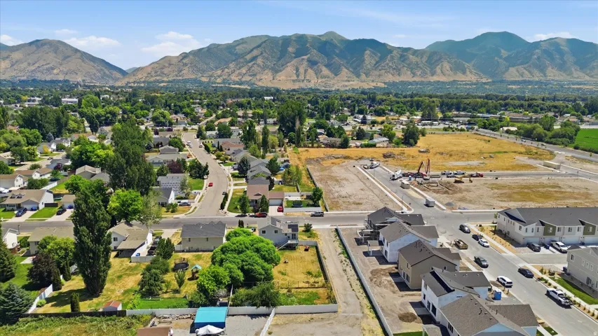 Expansive aerial perspective showcasing established residences, new construction homes, and developing residential parcels