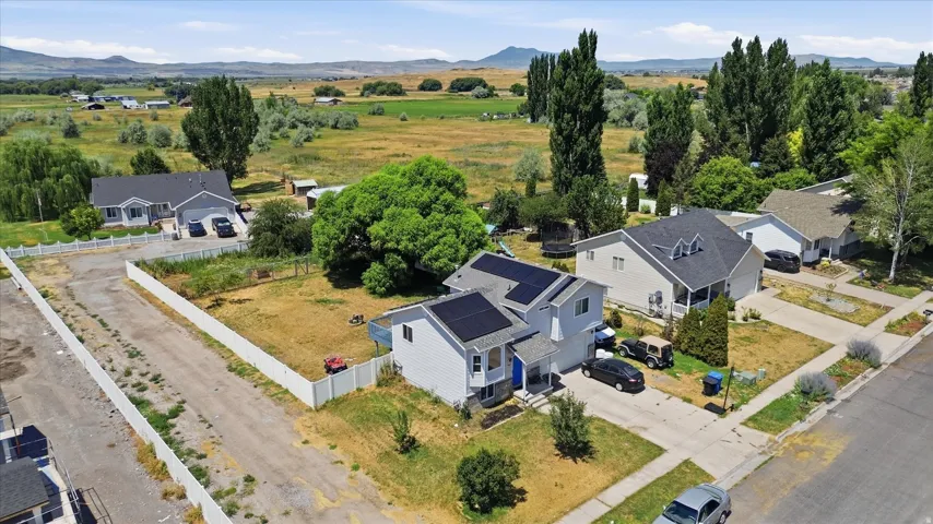 Contemporary two-story residence featuring solar panels, a gabled roofline, and an attached two-car garage