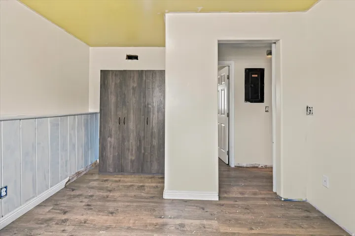 Wood-finish flooring throughout, complemented by a light-toned ceiling and white walls