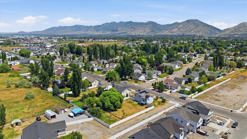 Expansive residential area featuring established homes, mature trees, and mountainous terrain in the distance