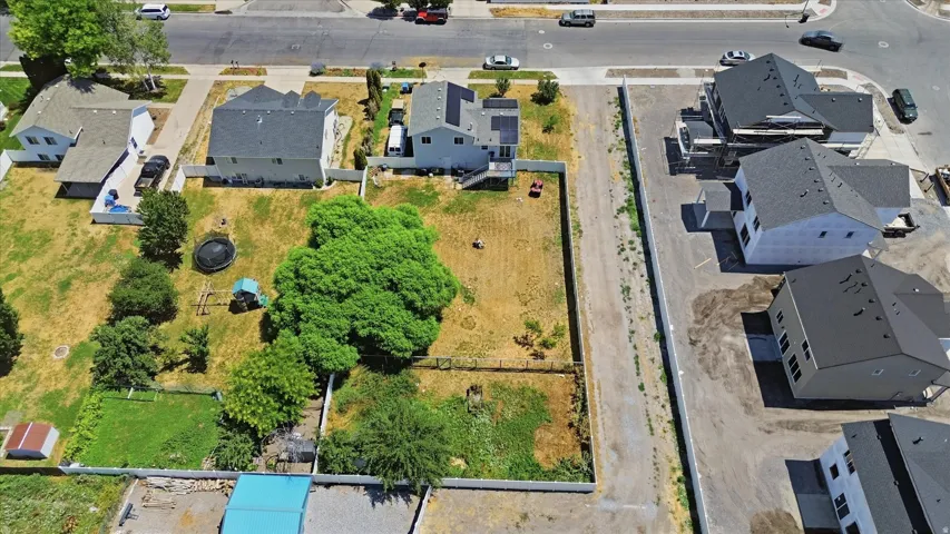 Expansive lot featuring mature trees and a substantial fenced backyard