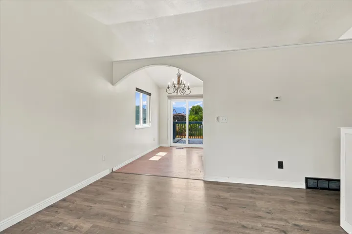 Interior space featuring wood-finish flooring, white baseboards, and light-colored walls