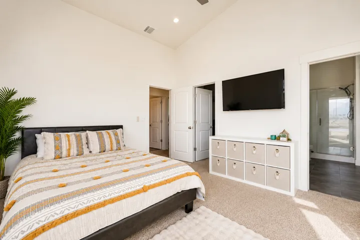 Vaulted ceiling with recessed lighting, carpet flooring, and white interior doors