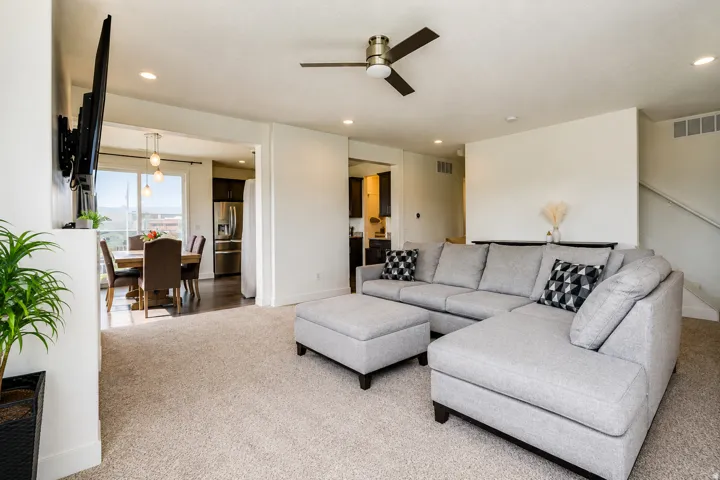 Recessed lighting, ceiling fan, carpeted flooring, hardwood-style flooring, and pendant lighting