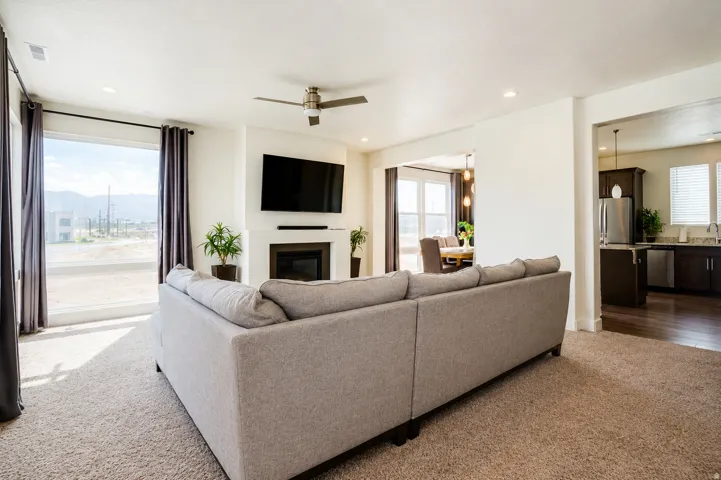 Open concept living area with recessed lighting and a ceiling fan