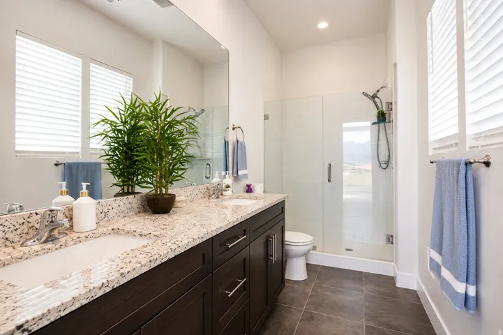 Dual vanity with light-toned stone countertops