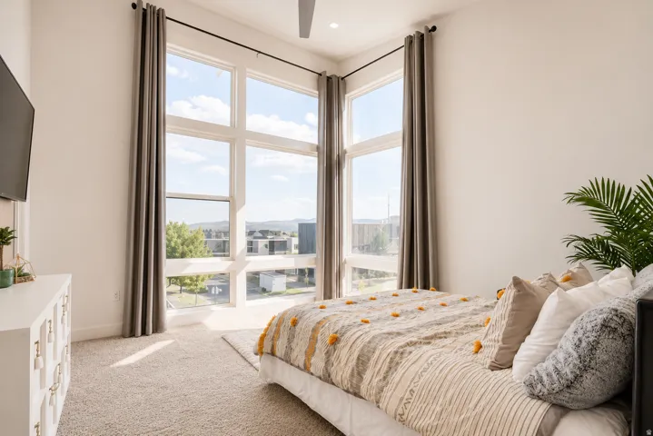 Soaring windows with multiple panes, recessed lighting, and soft carpeting