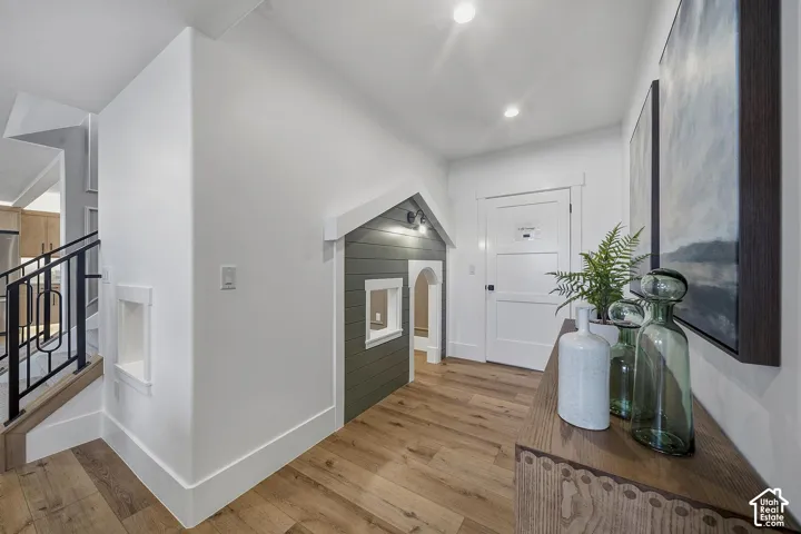 Hardwood-finish flooring throughout, complemented by crisp white trim and walls