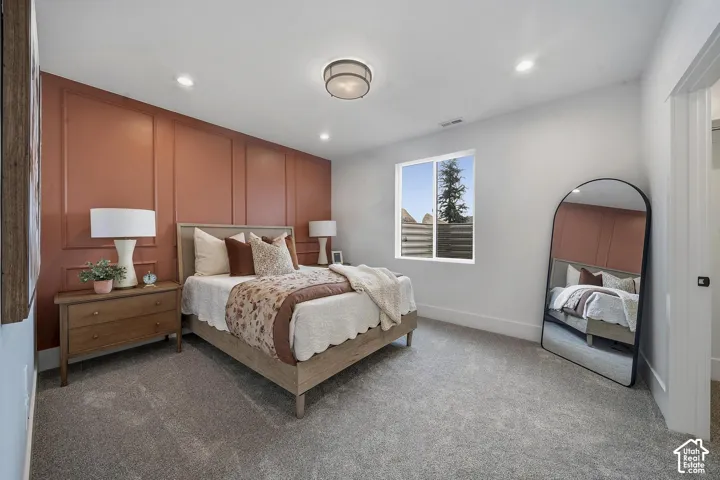 Accent wall with panel molding detail, recessed lighting, and a contemporary ceiling fixture