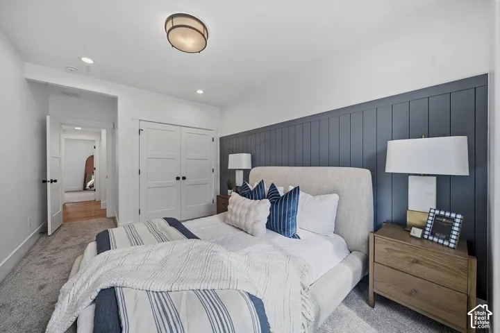 Bedroom featuring a textured accent wall, recessed lighting, and a flush-mount ceiling fixture