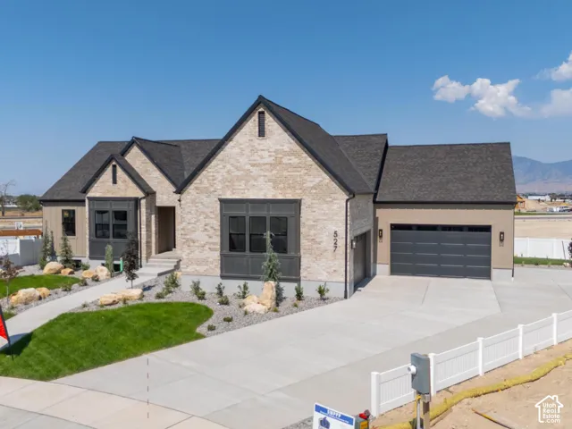 Contemporary single-story residence featuring light-colored brick and dark trim accents
