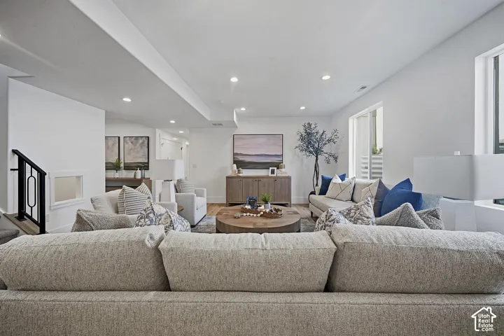 Open-concept living space with recessed lighting and light wood-finish flooring