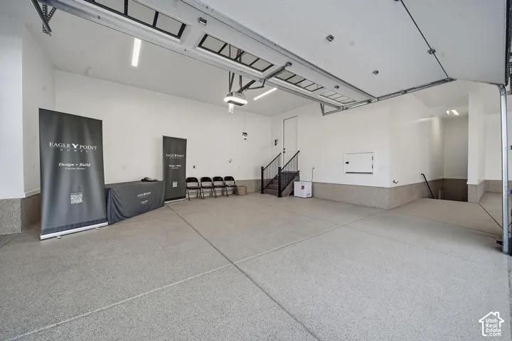 Spacious open floor plan with polished concrete flooring, recessed lighting throughout, and exposed ceiling infrastructure