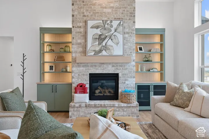 Sophisticated living room anchored by a floor-to-ceiling brick fireplace with gas insert and custom millwork