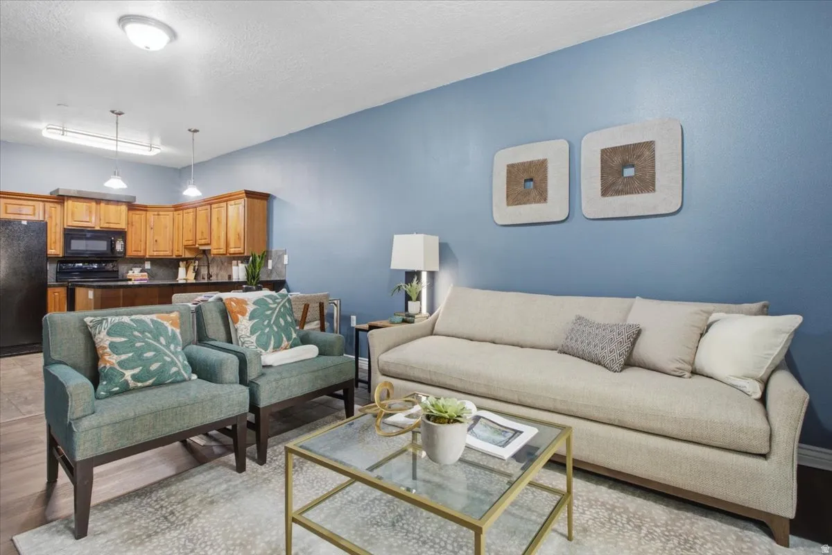 Open-concept living space featuring wood-finish flooring and light blue walls